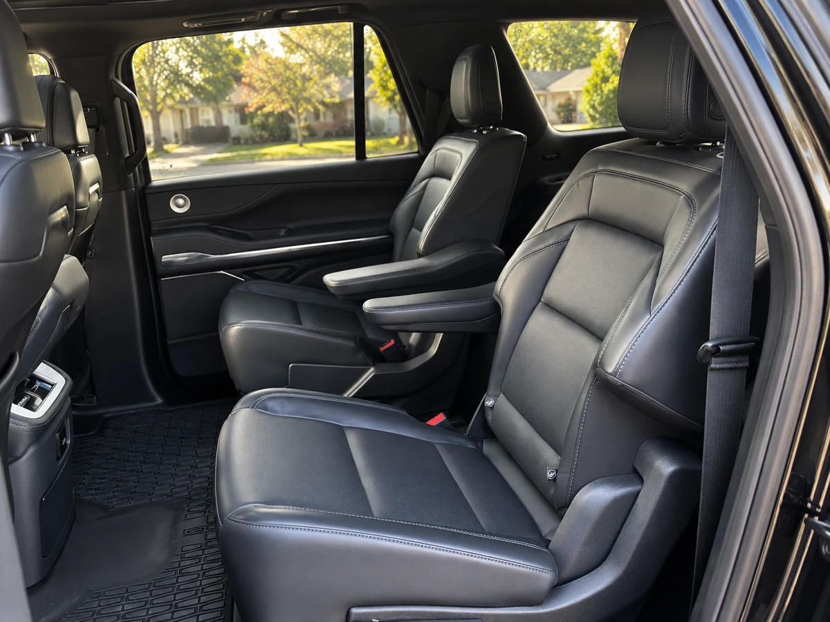 Recreated actual client Lincoln Navigator L black leather captain-chair cabin with a quiet Vienna neighborhood outside