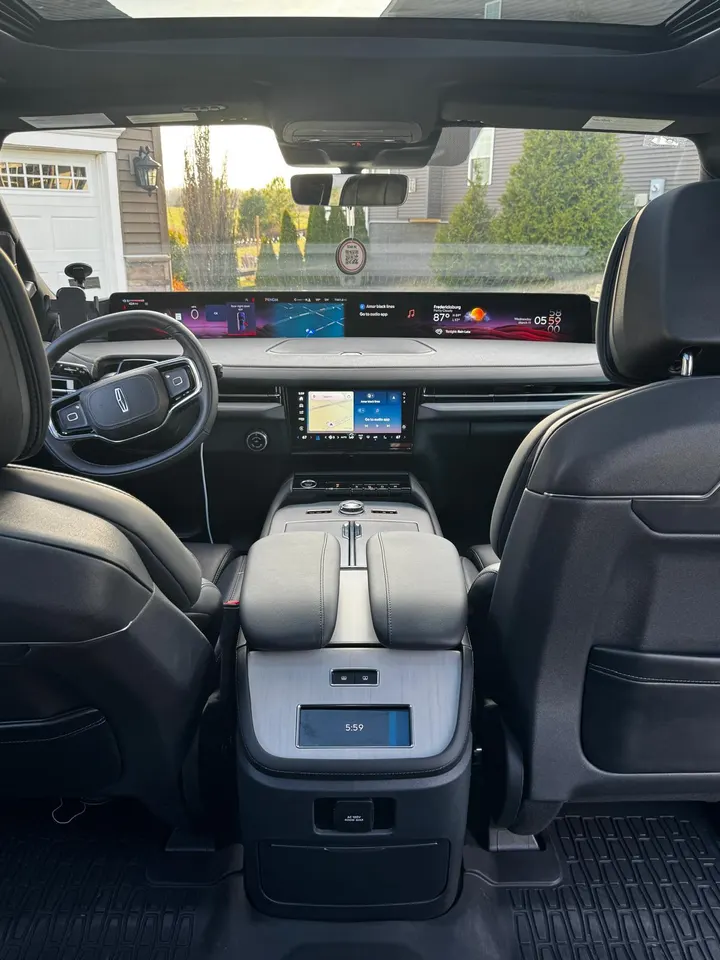Original Lincoln Navigator dashboard, center console and front seats viewed from the rear cabin