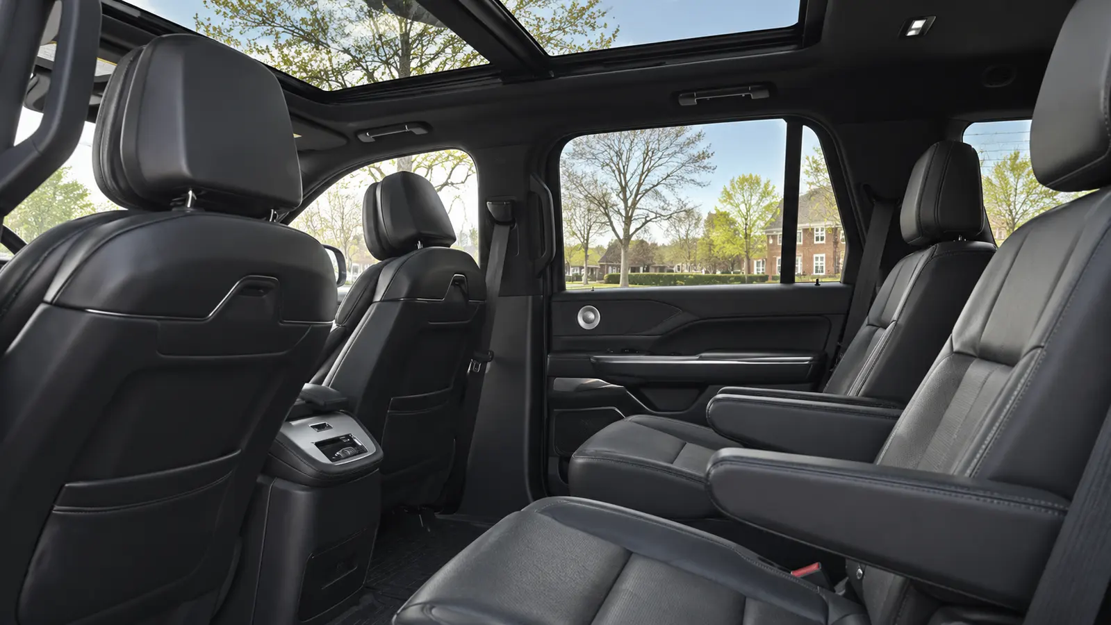 Client-reference black Lincoln Navigator cabin with captain chairs and panoramic roof