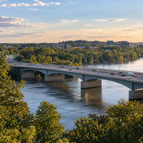 Tree-lined river crossing connecting destinations in the DMV